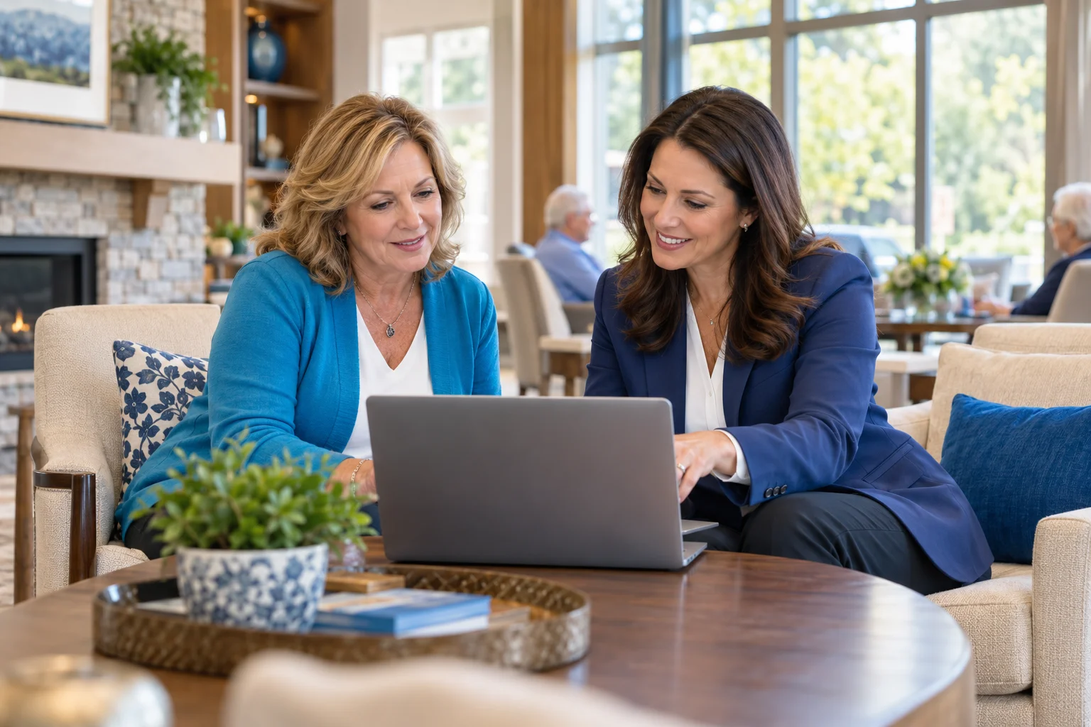 Illustrative community director and advisor discussing a community on a laptop.
