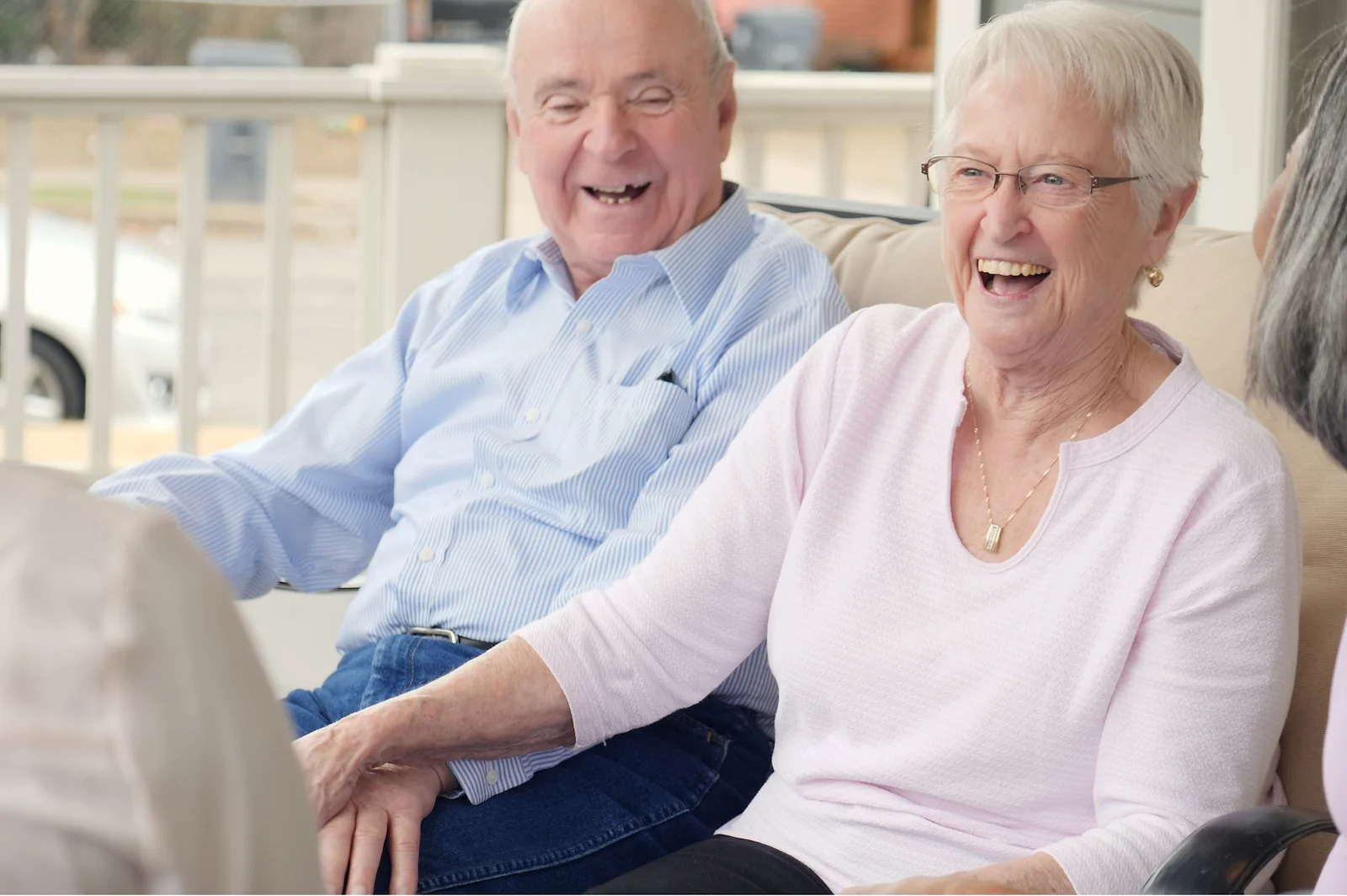 Senior couple laughing together during a visit in a bright common area