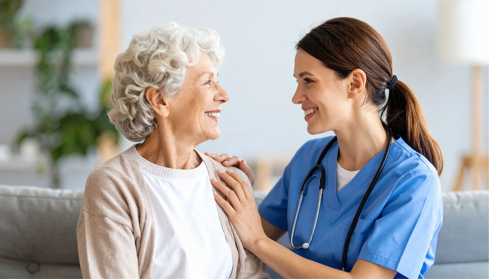 Nurse providing compassionate home health care services to senior woman in a bright living room