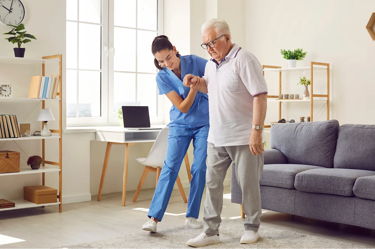 Physical therapist helping senior man with balance and mobility exercises
