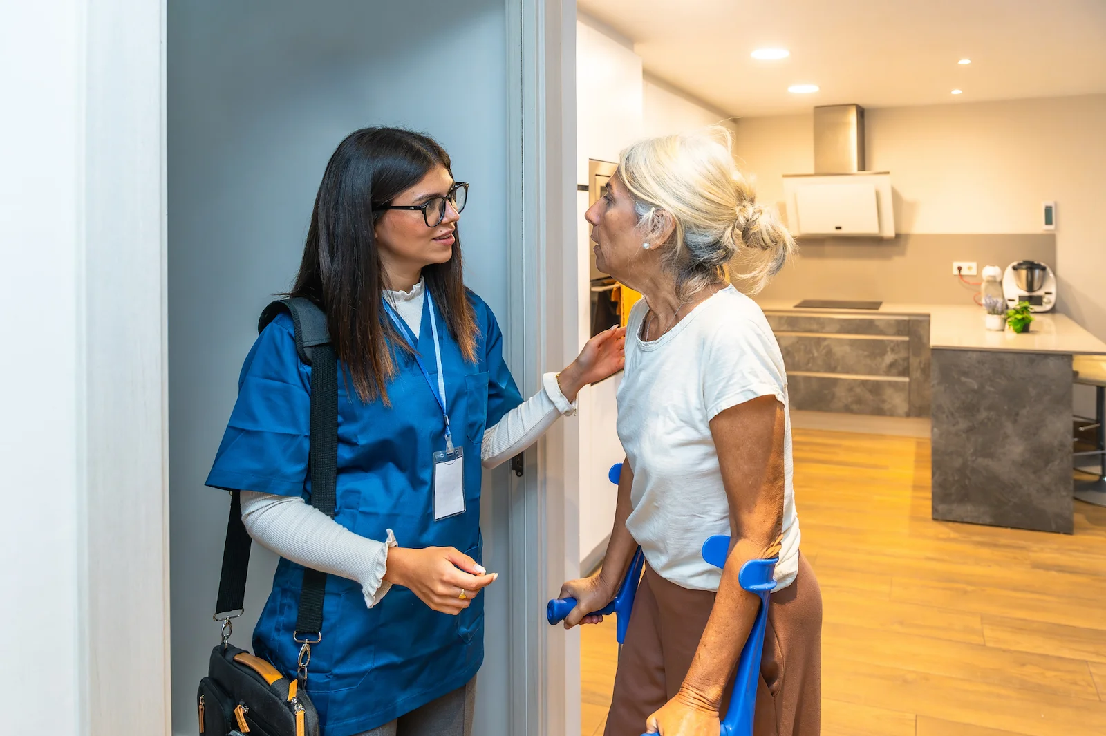 Healthcare professional arriving at senior woman's home with medical bag