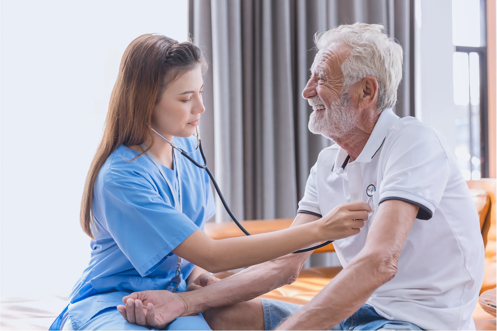 Healthcare professional checking senior man's blood pressure during home visit