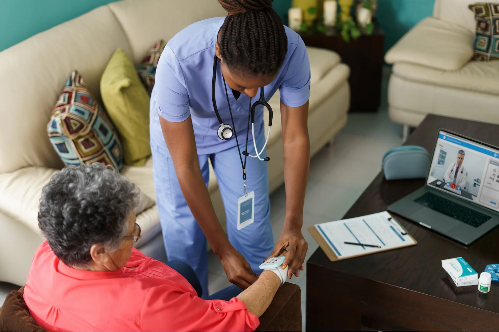 Nurse taking senior woman's pulse during a home health assessment