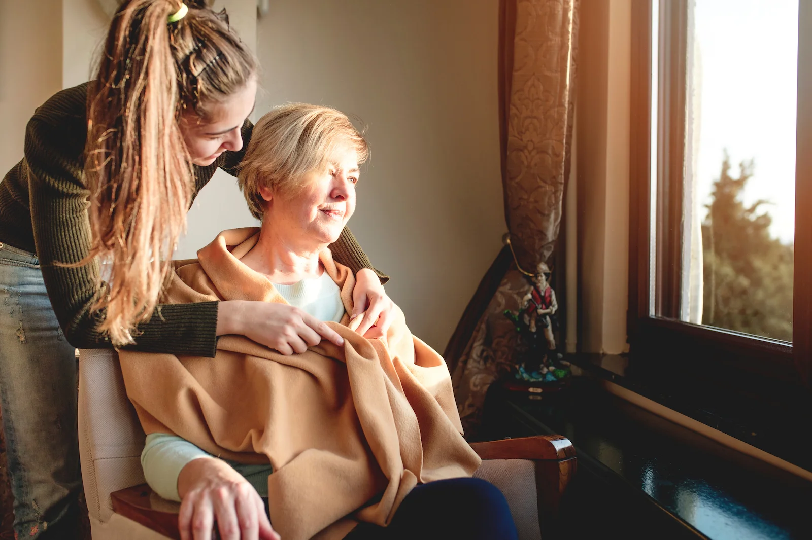 Hospice nurse checking on patient at home