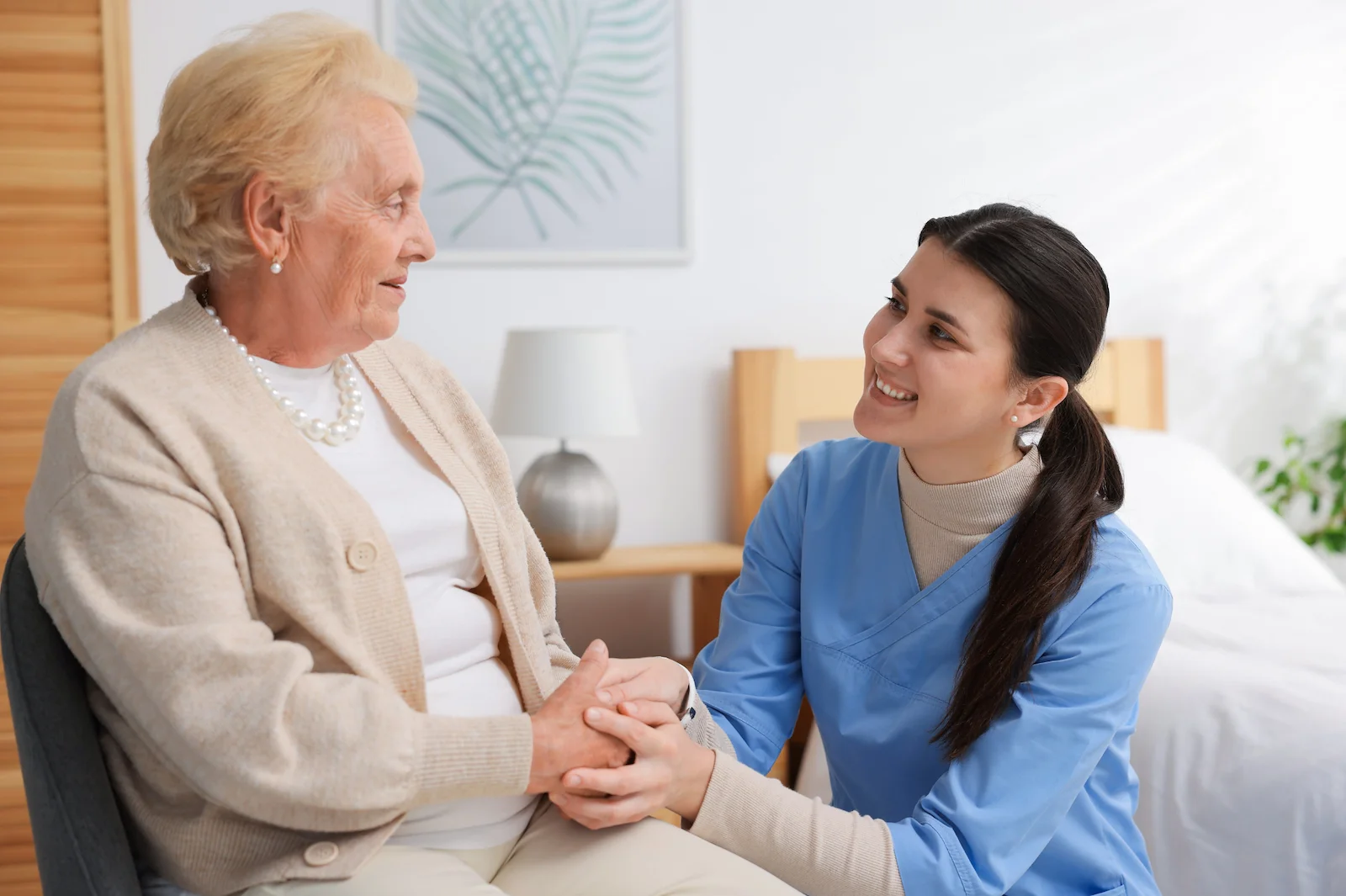 Compassionate caregiver providing emotional support to elderly resident