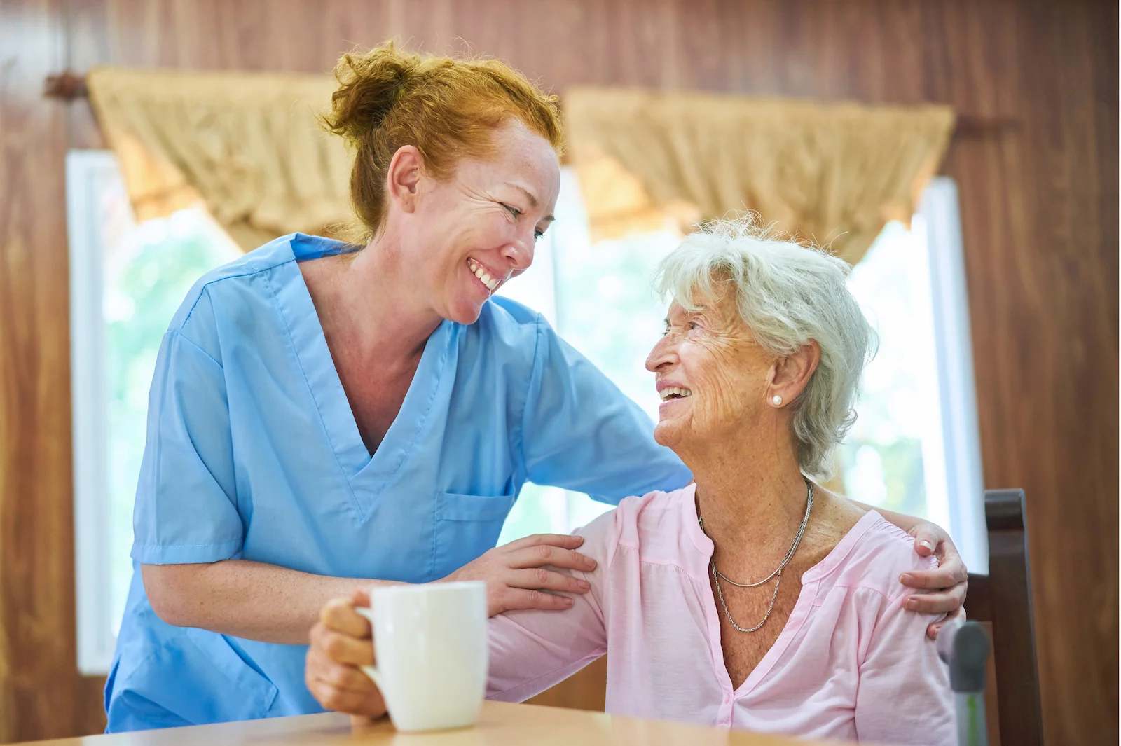 Caregiver providing warm companionship to senior resident