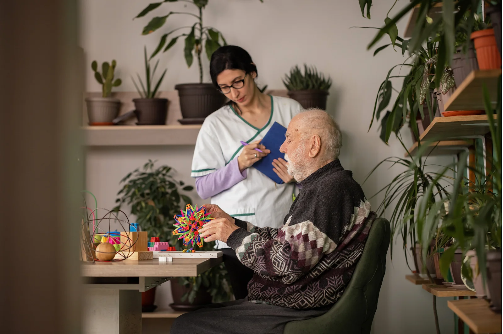 Caregiver assisting senior with cognitive therapy activities