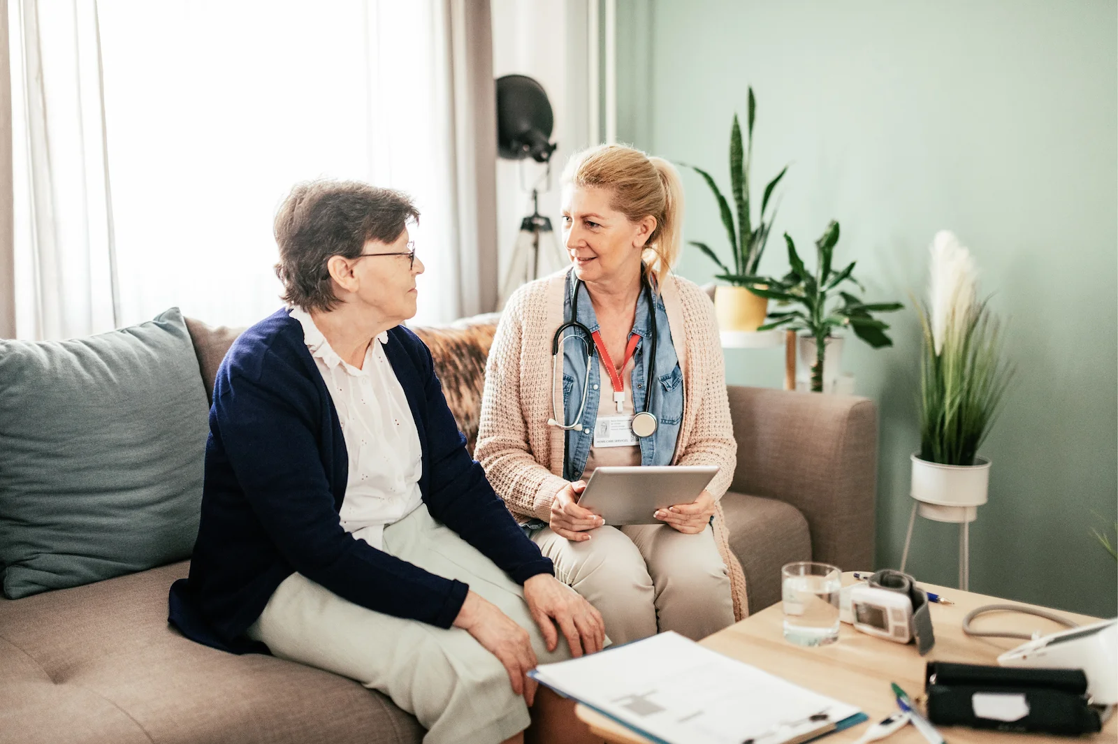 Healthcare professional consulting with senior resident at home