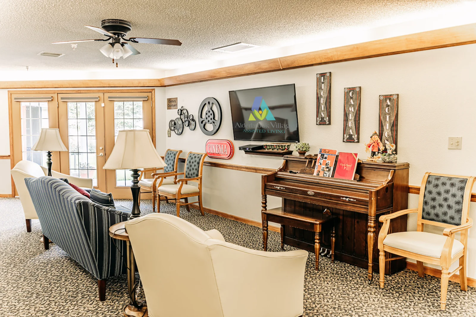 Alderbrook Village assisted living community in Arkansas City, KS, community gathering area with seating and a piano for entertainment