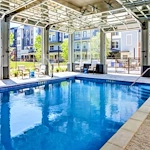 Watermere at Woodland Lakes senior living community offering active adult living and independent living in Conroe, TX, indoor pool with large garage doors that open up to the outdoors