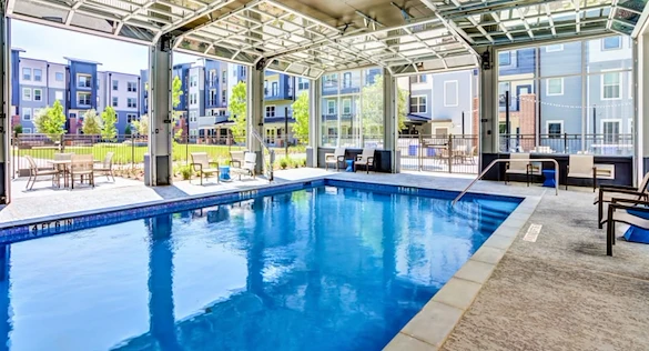 Watermere at Woodland Lakes senior living community offering active adult living and independent living in Conroe, TX, indoor pool with large garage doors that open up to the outdoors