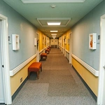 Wesley Manor Assisted Living Community offering assisted living and continuing care retirement community (CCRC) services in Louisville, KY, hallway with blue on the upper portion of the walls and yellow on the lower portion