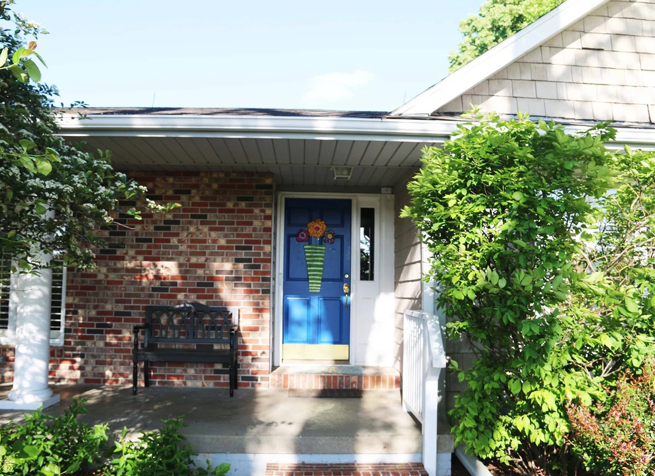Legato Living Residential Memory Care at Legacy senior living community offering assisted living, memory care, adult day services, and respite care in Omaha, NE, entrance featuring a blue front door
