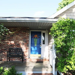 Legato Living Residential Memory Care at Legacy senior living community offering assisted living, memory care, adult day services, and respite care in Omaha, NE, entrance featuring a blue front door