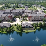 Active adult living and independent living at Watercrest at Mansfield in Mansfield, TX, community exterior with a pond in view