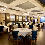 Watermere at Frisco senior living community offering active adult living and independent living in Frisco, TX, featuring a formal dining room with elegant lighting, upscale finishes, and refined décor