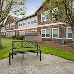 Avamere at Seaside senior living community offering independent living, assisted living, memory care, and respite care in Seaside, OR, outdoor area with a bench