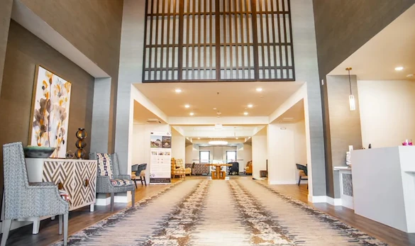 Watermere at the Preserve senior living community offering active adult living and independent living in North Richland Hills, TX, lobby with high ceilings and seating options