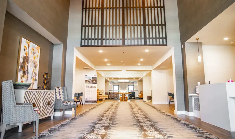 Watermere at the Preserve senior living community offering active adult living and independent living in North Richland Hills, TX, lobby with high ceilings and seating options