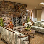 Avamere at Seaside senior living community offering independent living, assisted living, memory care, and respite care in Seaside, OR, sitting area by fireplace
