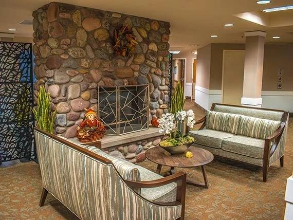 Avamere at Seaside senior living community offering independent living, assisted living, memory care, and respite care in Seaside, OR, sitting area by fireplace