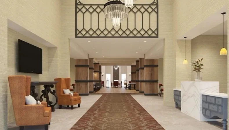 Watermere at Flower Mound senior living community offering active adult living and independent living in Flower Mound, TX, featuring a welcoming lobby with a front desk and orange chairs