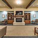 Aspens at Fort Collins Senior Living, senior living community offering assisted living, memory care, and respite care in Fort Collins, CO, common space by a fireplace