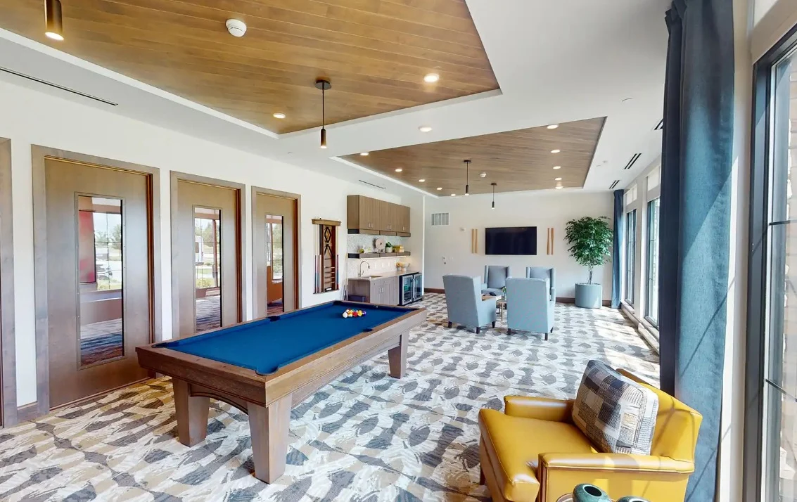 CopperWood at Prairie Trail senior living community offering assisted living and memory care in Ankeny, IA, activities room with a pool table