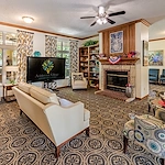 Ashbrook Village senior living community offering independent living, assisted living, and memory care in Duncan, OK, community lounging area by a fireplace