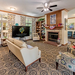 Ashbrook Village senior living community offering independent living, assisted living, and memory care in Duncan, OK, community lounging area by a fireplace