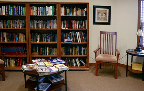 Enjoy our fully stocked library with space for private reading.