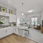 Alto Johns Creek, senior living community offering assisted living, memory care, and respite care in Duluth, GA, apartment featuring a kitchenette and comfortable living area