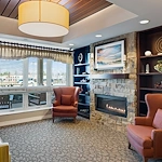 Alto Grayslake, senior living community offering assisted living, memory care, and respite care in Grayslake, IL, community living room with a fireplace