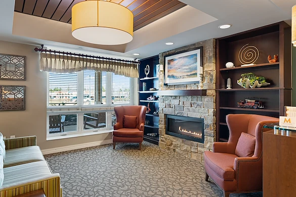 Alto Grayslake, senior living community offering assisted living, memory care, and respite care in Grayslake, IL, community living room with a fireplace