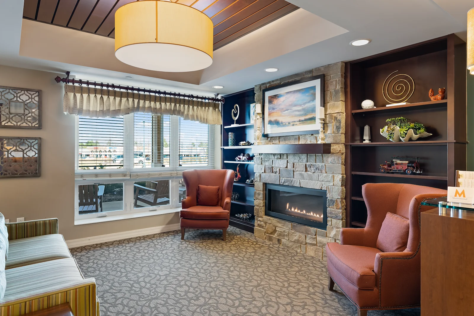 Alto Grayslake, senior living community offering assisted living, memory care, and respite care in Grayslake, IL, community living room with a fireplace