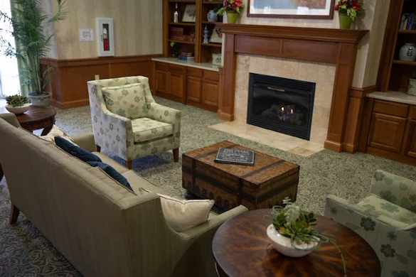 Allisonville Meadows Assisted Living offering assisted living, memory care, and respite care in Fishers, IN, lounge area by a fireplace