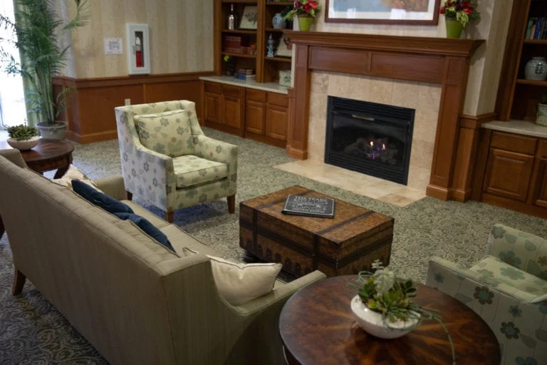 Allisonville Meadows Assisted Living offering assisted living, memory care, and respite care in Fishers, IN, lounge area by a fireplace