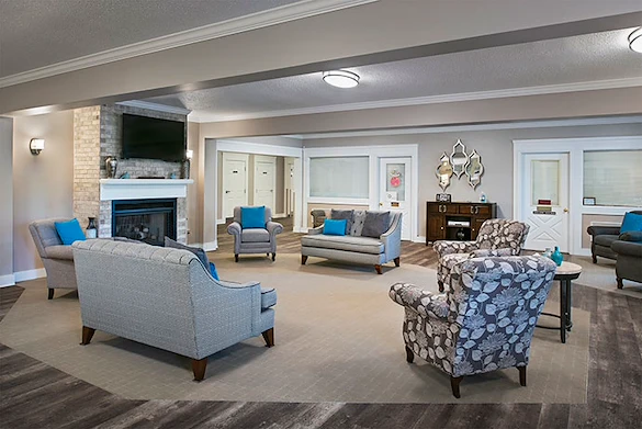 American House Dearborn Heights, senior living community offering independent living and respite care in Dearborn Heights, MI, community living room with seating by a fireplace