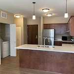 Independent living, assisted living, memory care, and respite care at Broadwell Senior Living – Plymouth in Plymouth, MN, apartment kitchen and laundry