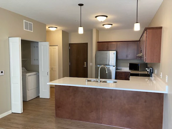 Independent living, assisted living, memory care, and respite care at Broadwell Senior Living – Plymouth in Plymouth, MN, apartment kitchen and laundry