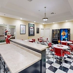 Assisted living and memory care at Bridgewater Memory Care in Granbury, TX, community kitchen and sitting area with a diner-style theme