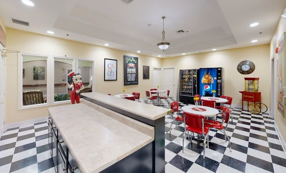 Assisted living and memory care at Bridgewater Memory Care in Granbury, TX, community kitchen and sitting area with a diner-style theme