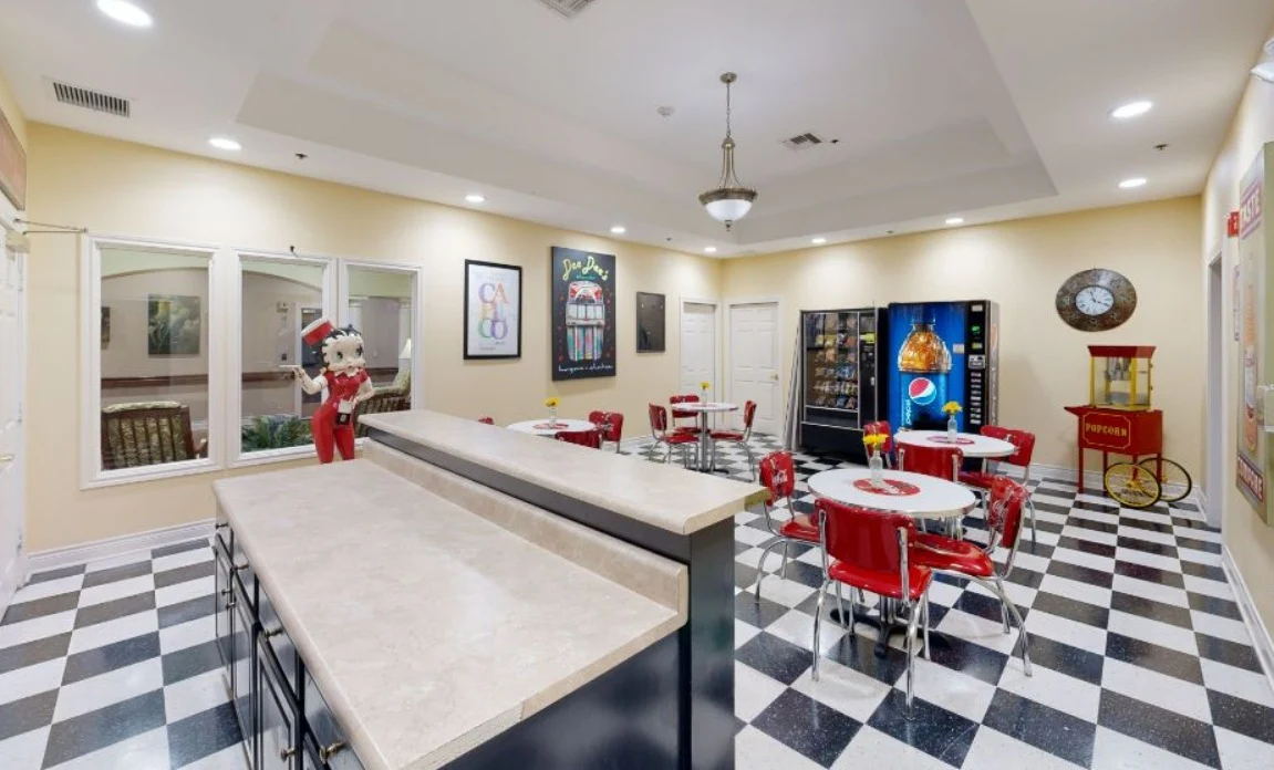 Assisted living and memory care at Bridgewater Memory Care in Granbury, TX, community kitchen and sitting area with a diner-style theme