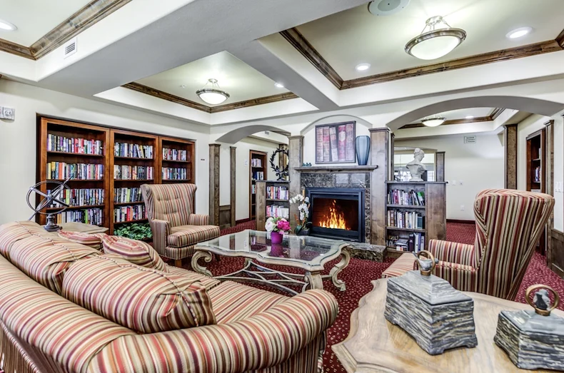 Alexis Estates Gracious Retirement Living by Hawthorn Senior Living, independent living in Allen, TX, sitting area by fireplace for socializing or reading