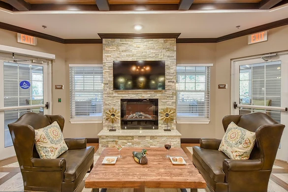 Anthem Lakes, senior living community offering independent living, assisted living, and memory care in Jacksonville, FL, sitting area by fireplace