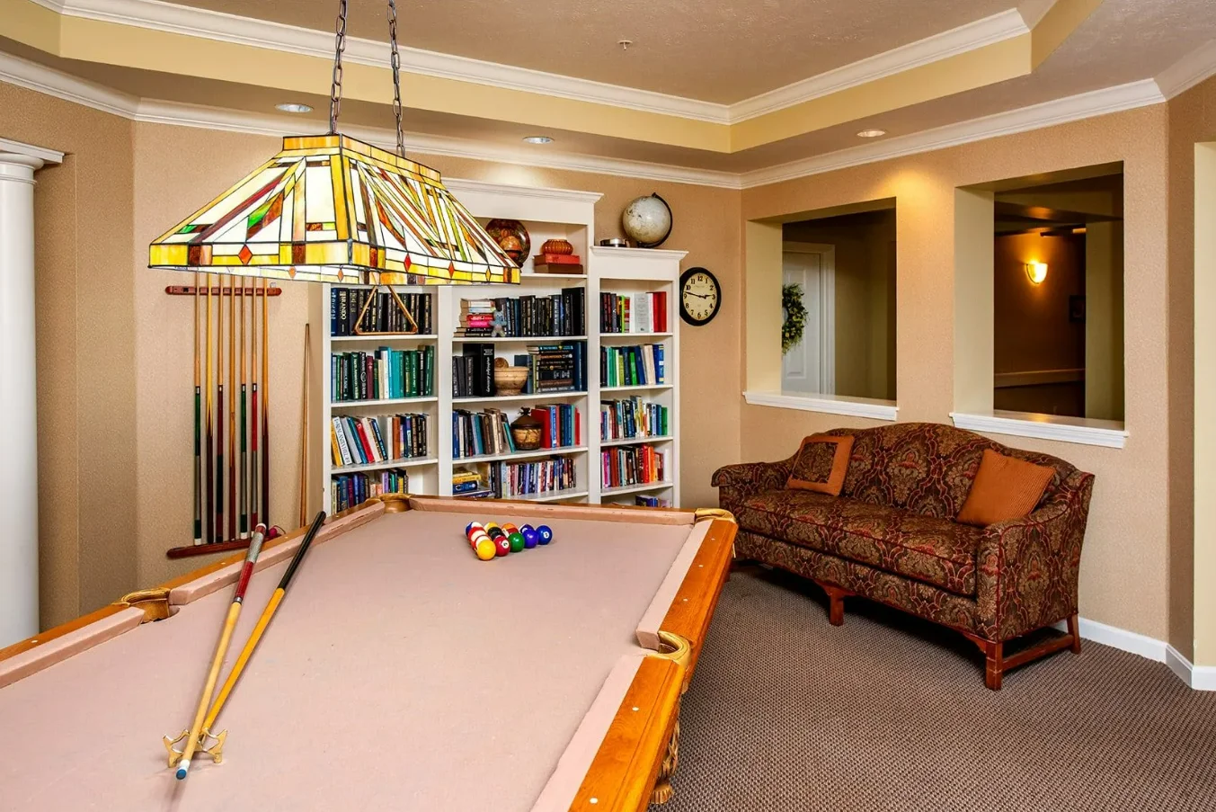 Westlake Woods by New Perspective senior living community offering assisted living in Erie, PA, activity room with bookshelves filled with books and a pool table for recreation