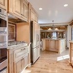 Legato Living Residential Memory Care at Rockbrook senior living community offering assisted living and memory care in Omaha, NE, kitchen with wooden cabinets and stainless steel appliances