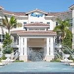Allegro Parkland, senior living community offering independent living, assisted living, memory care, and respite care in Parkland, FL, front entrance with water feature