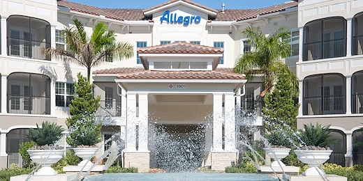 Allegro Parkland, senior living community offering independent living, assisted living, memory care, and respite care in Parkland, FL, front entrance with water feature