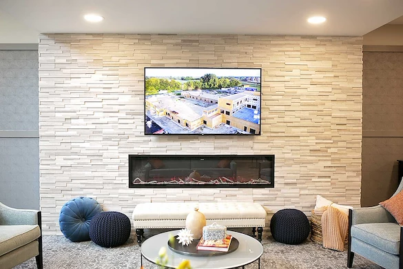 Astral at Auburn, senior living community offering independent living, assisted living, and memory care in Auburn, IN, sitting area by fireplace